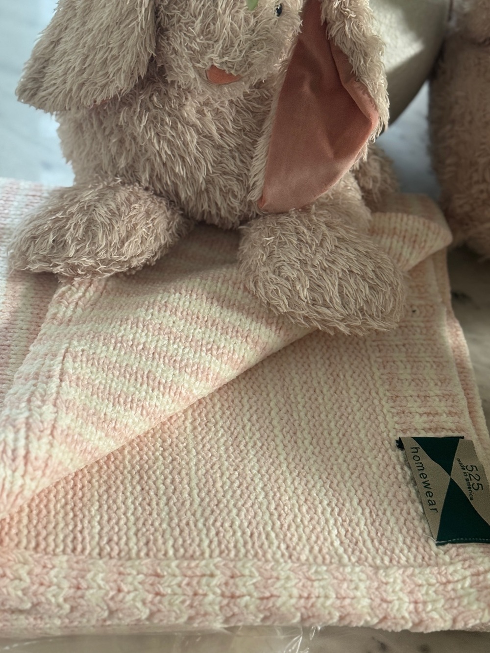 Striped pink and white knit baby blanket